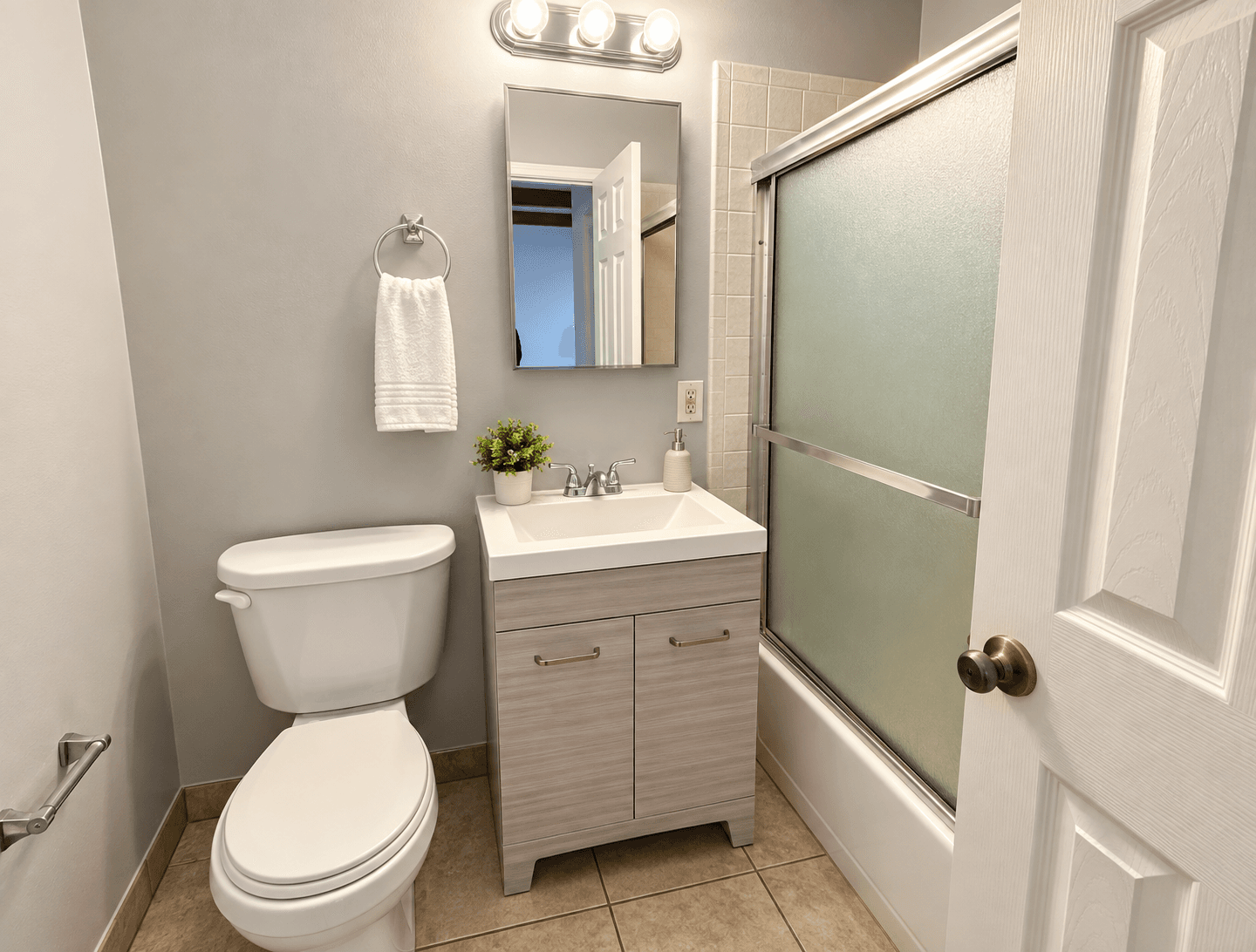 Private studio bathroom with a shower, toilet and vanity