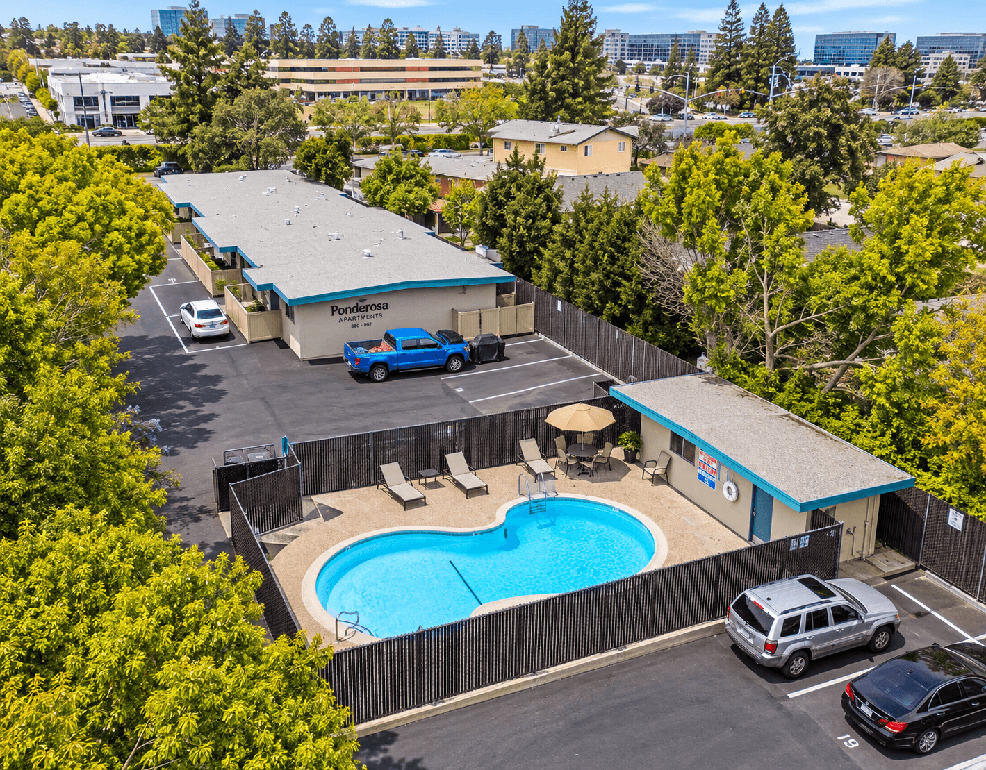 Aerial view of the community pool, sun deck and surrounding apartments